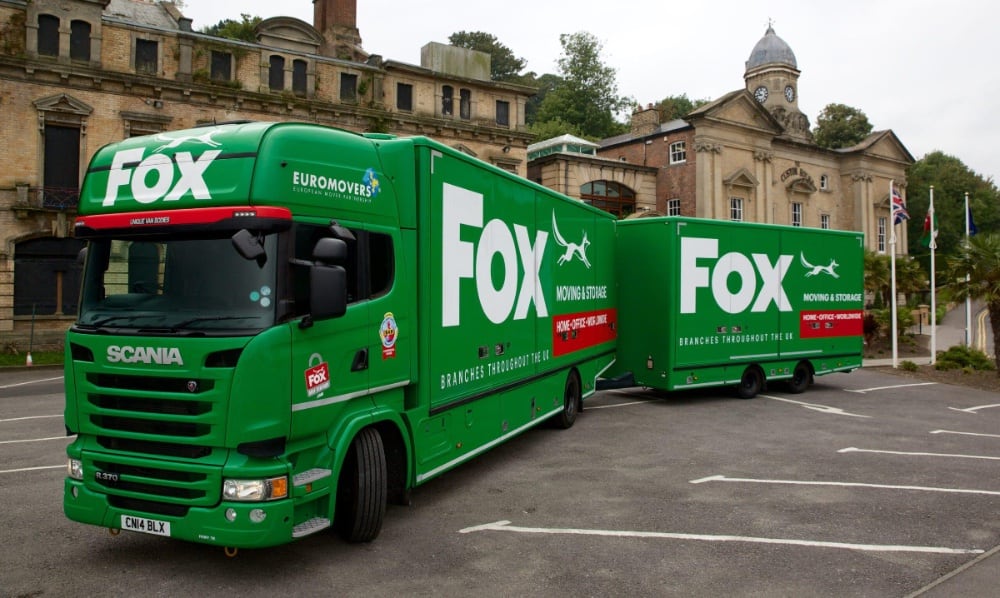 fox moving and storage vans outside the custom house building in penarth
