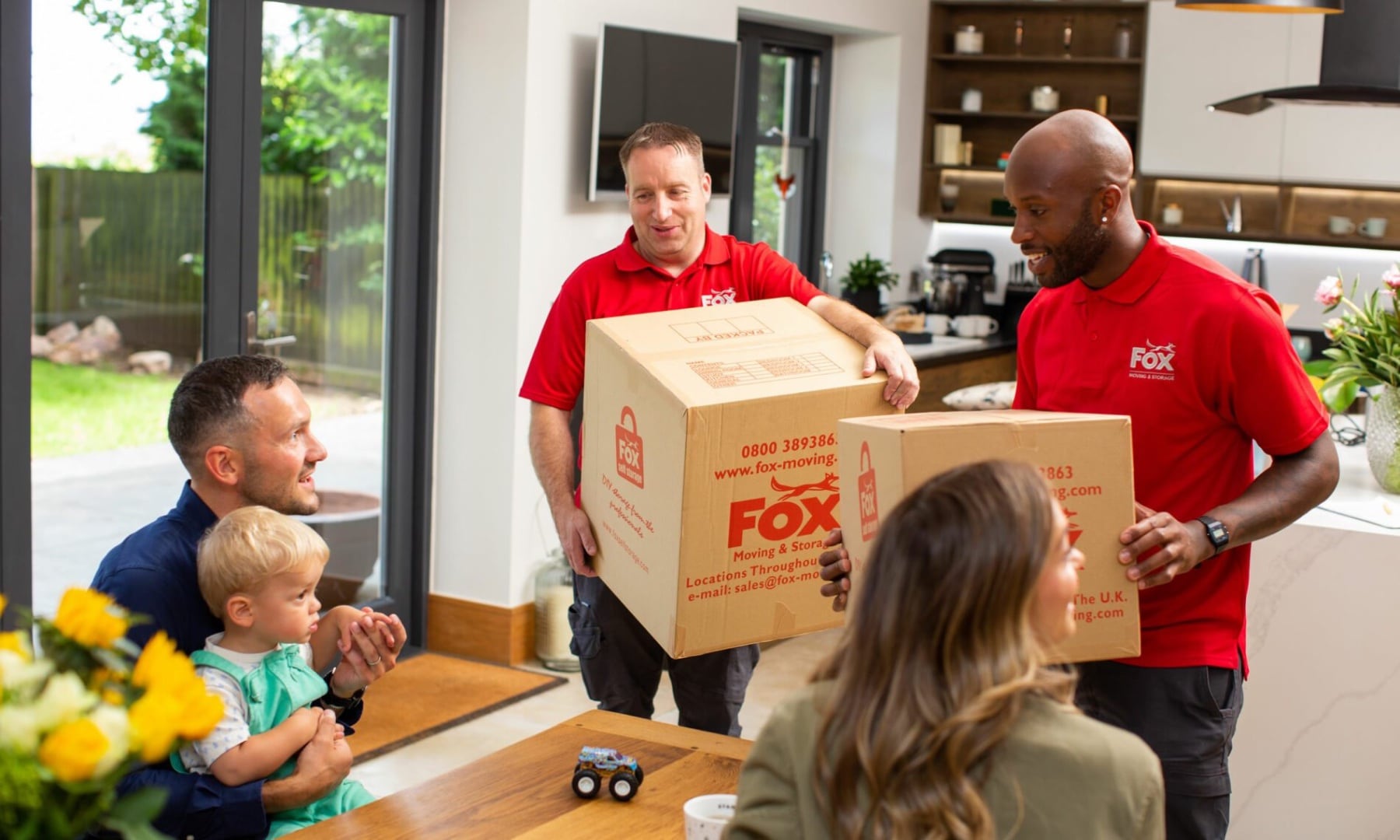 fox moving and storage movers carrying boxes during a move