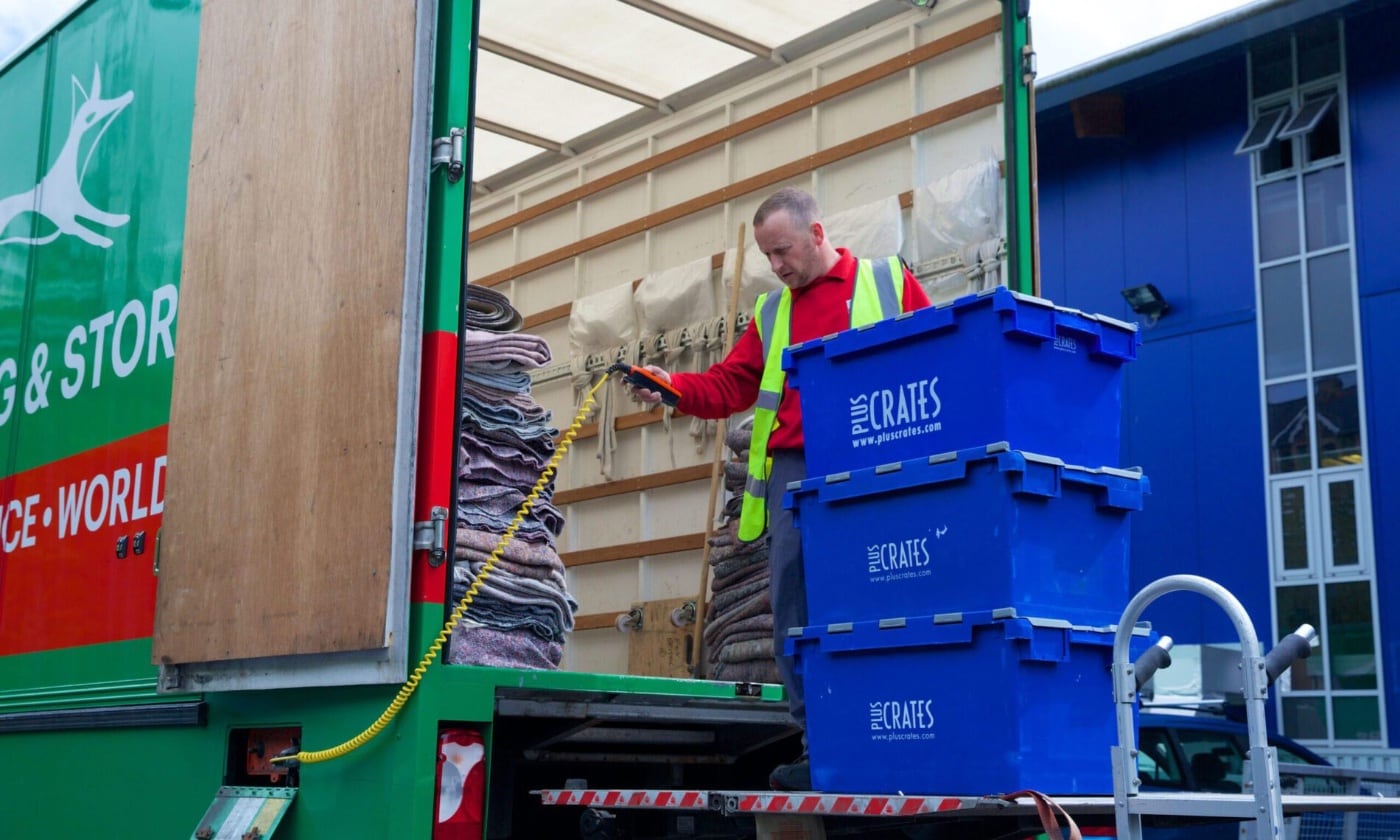 fox moving and storage mover loading crates into a van