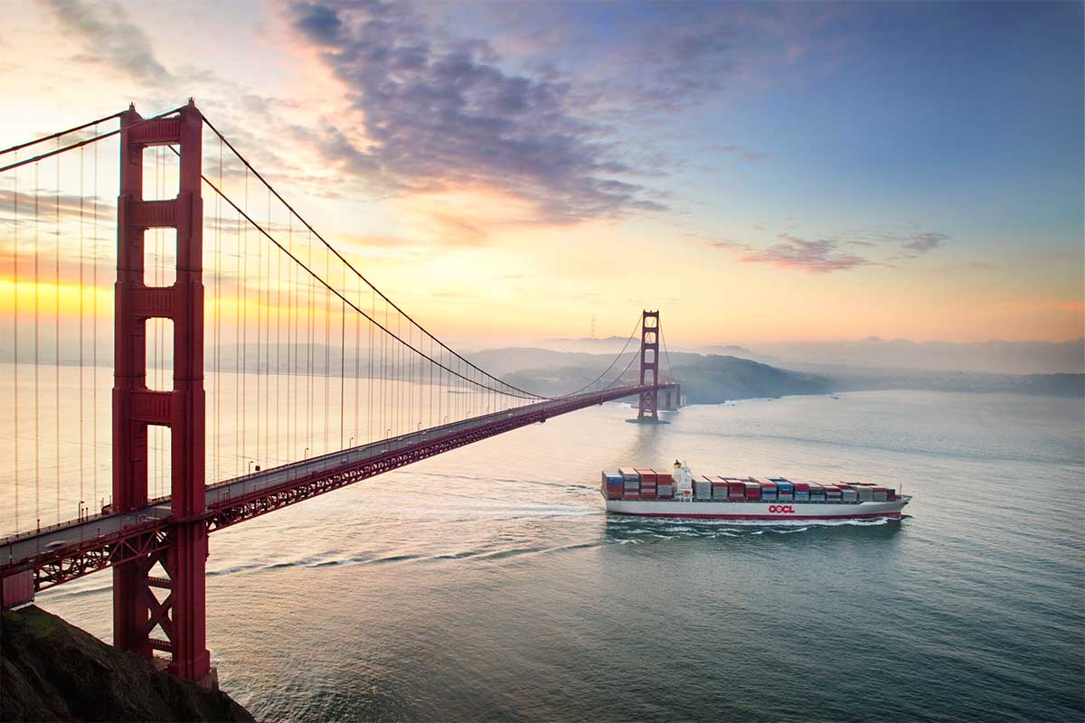 container ship going past the golden gate bridge